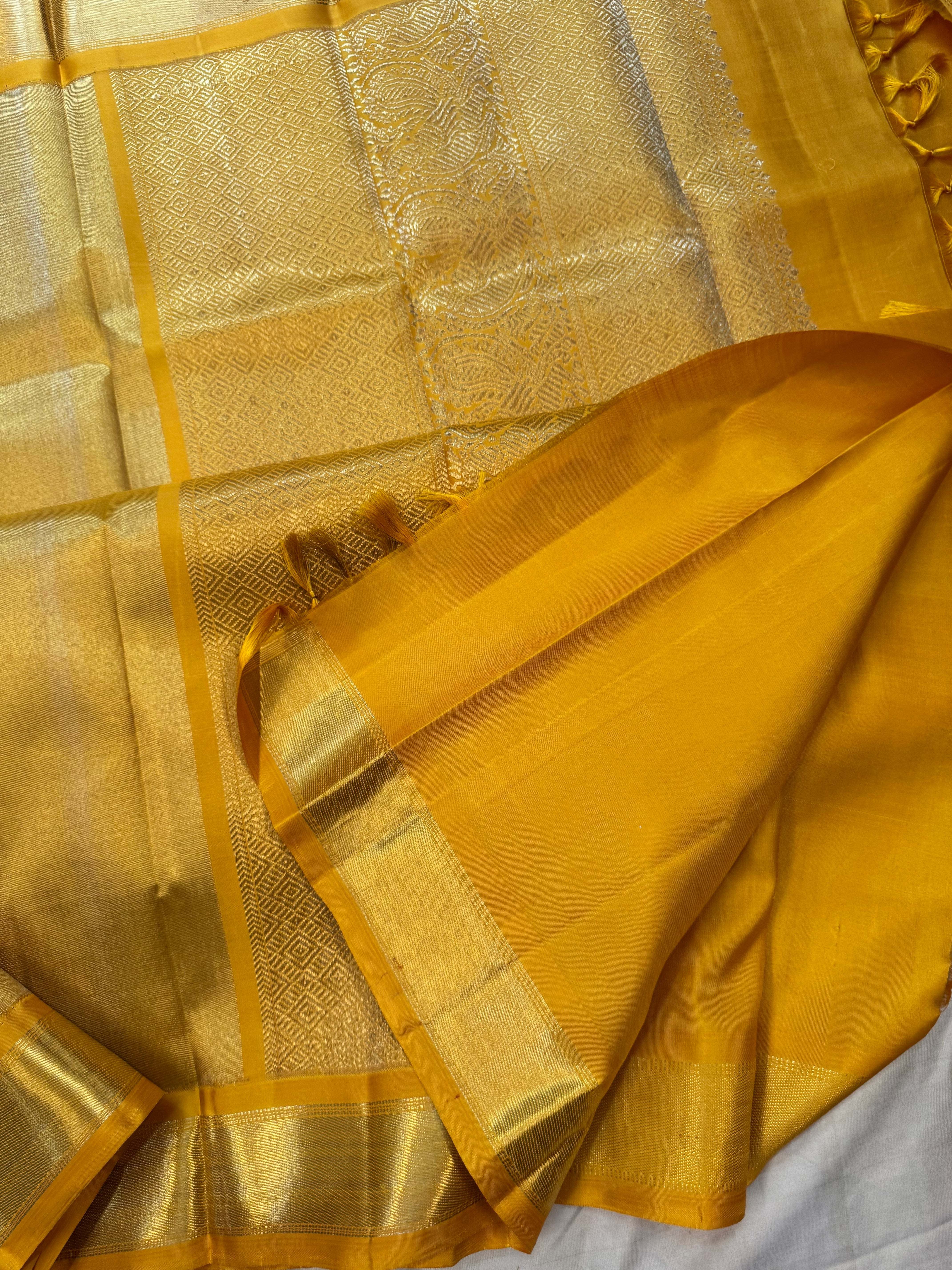 Golden mustard yellow berhampuri style long Palla kanjipuram silk.