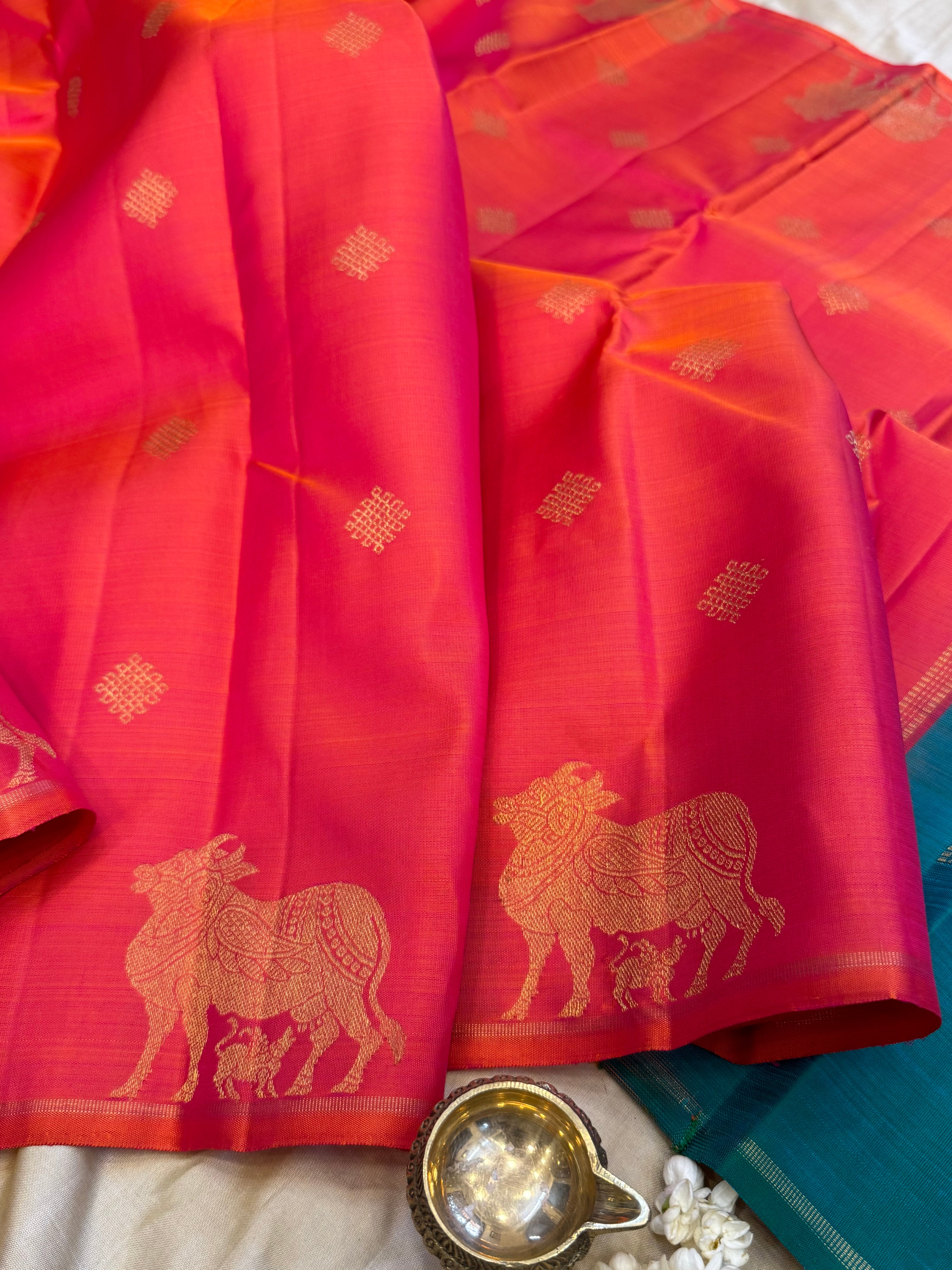 Pinkish orange and mayilkazhuthu komatha and kolam butta / Kanjipuram Silk